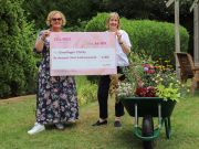 Linda Petrons being presented with a cheque by Sarah Squire.